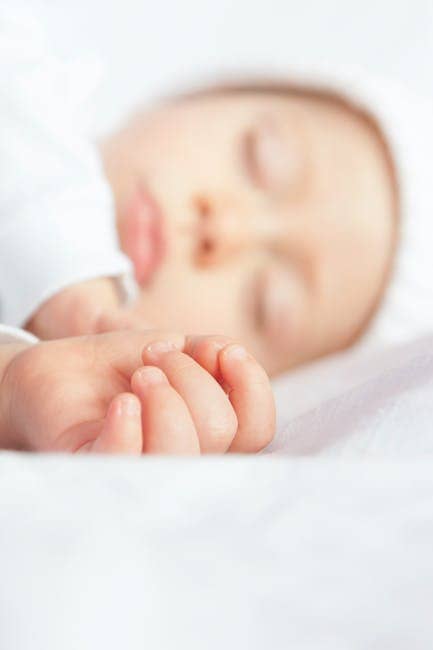 Baby Lying On White Textile