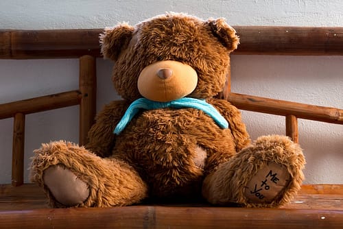 Brown Teddy Bear on Brown Wooden Chair