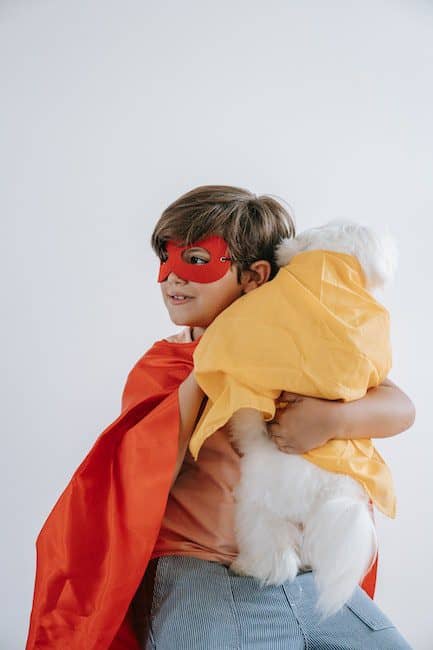 A Boy Wearing a Costume With His Dog