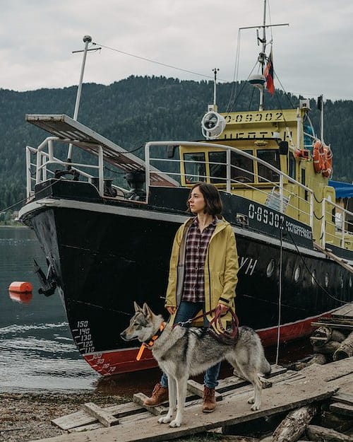 Woman with Dog near Moored Ship