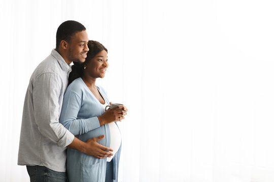Happy african american expecting family looking at copy space