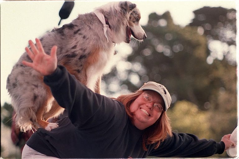 File:Dog owner and dog at Pet Pride Day, 2002.jpg - a woman holding a dog up in the air