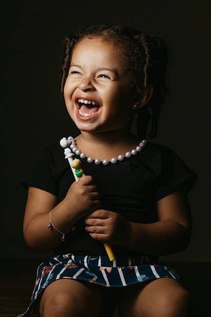Cheerful girl with pencil in studio